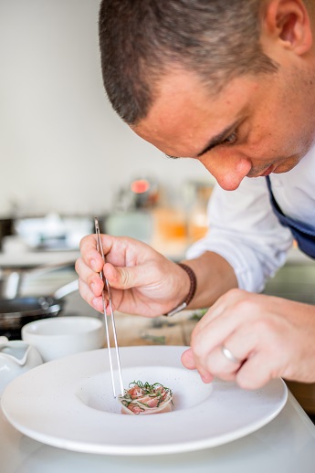 Chef julien royer of odette works towards making the seasonal and delicious tuna flower.