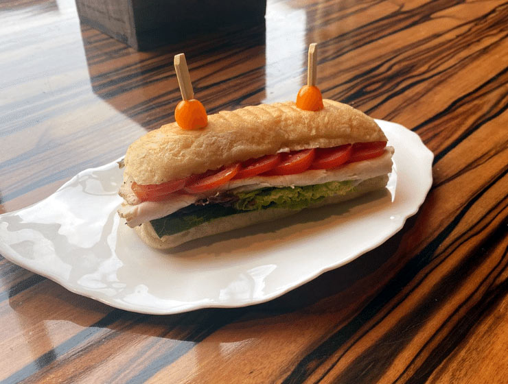 Cheesy grilled turkey panini with forest berry jam featured