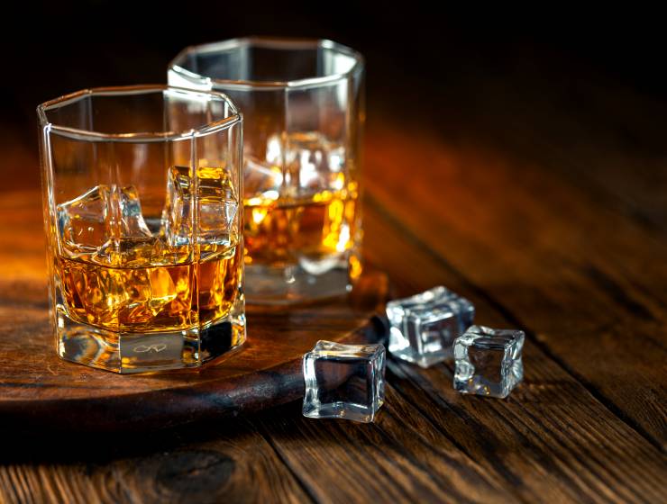 The glass of whiskey with ice.